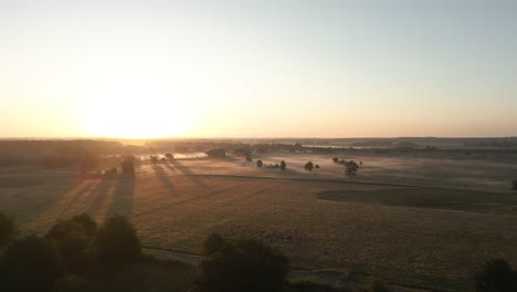 sunrise over a misty field