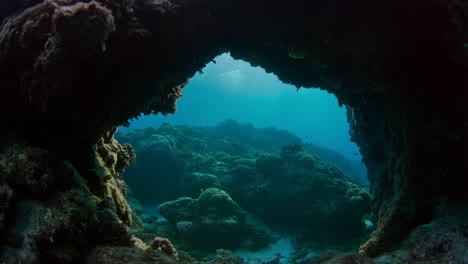underwater cave archway overlooking coral reef