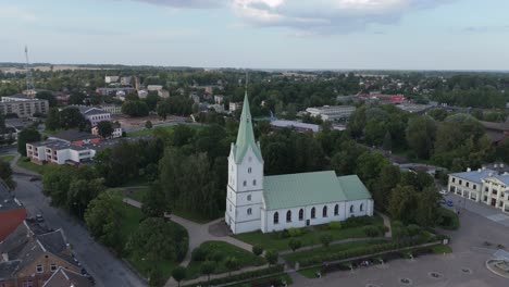 aerial panorama of dobele town center and evangelical lutheran church at summer scenic drone view in golden hour light over dobeles historic center on a warm summer evening peaceful latvian town