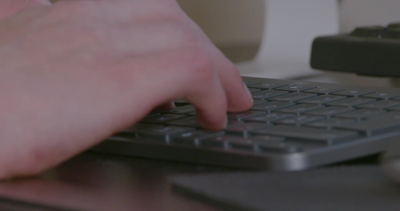 Close-Up of a Hand Typing on a Modern Keyboard