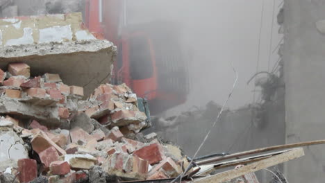 a house is being demolished by an excavator, demolition site