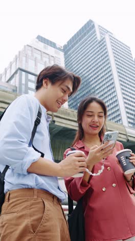 two people in the city using a smartphone