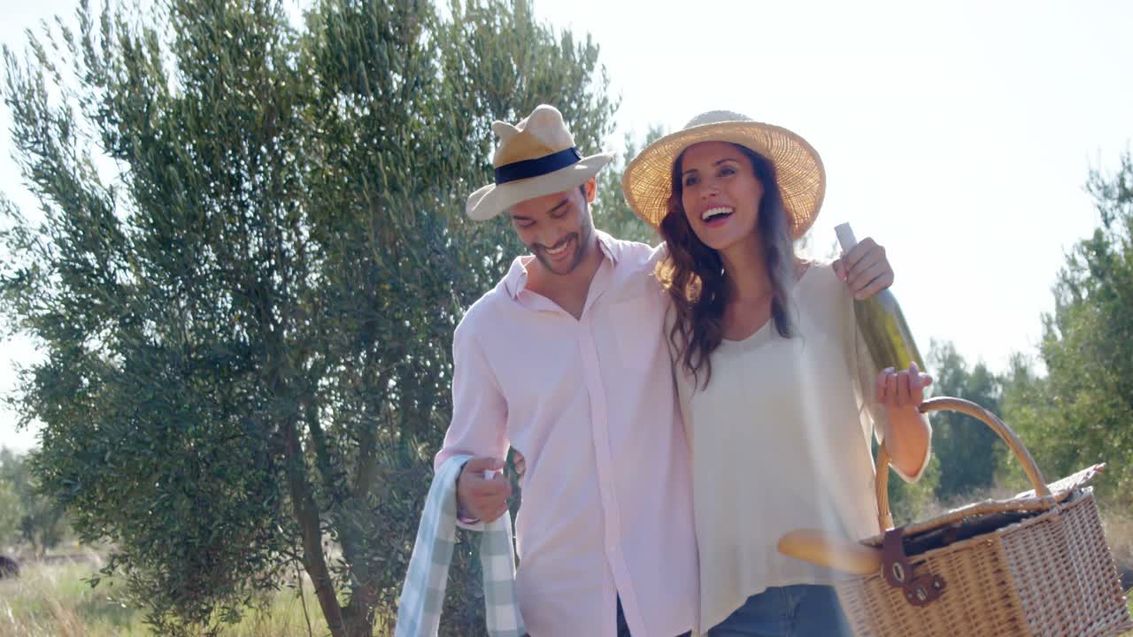 Romantic couple walking with wicker basket in olive farm 4k