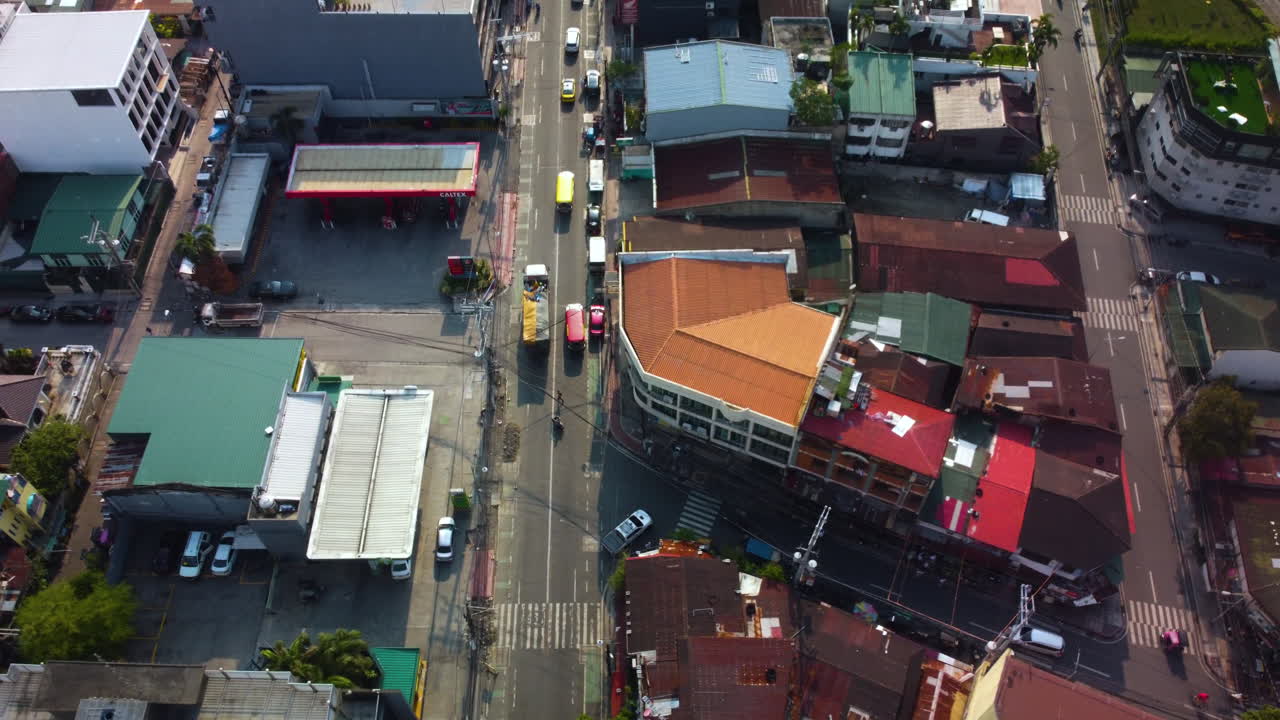 Aerial view rotating around traffic on the street of Manila, in sunny Philippines