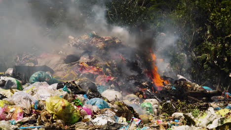 burning of waste with flames and smoke rising