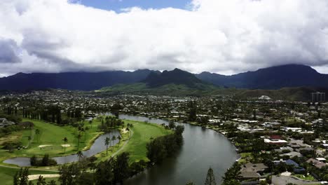 drone shot of wealthy homes lining a river in kailua, hawaii