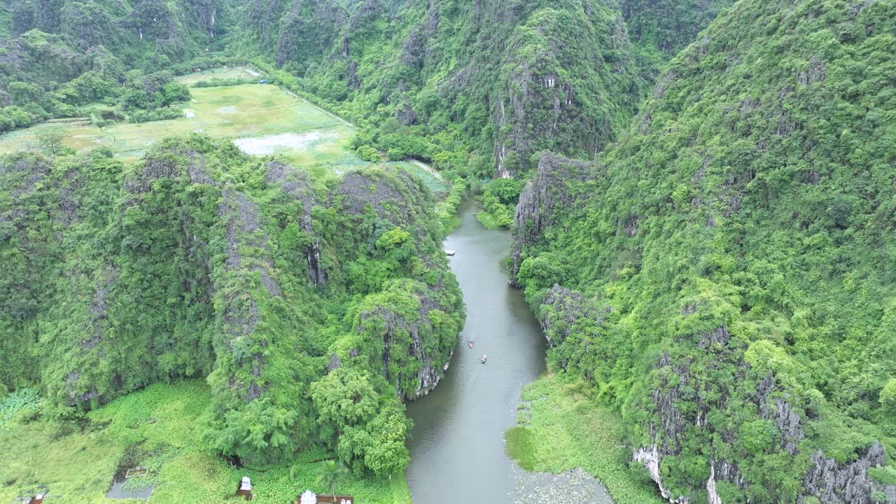 Serene boat ride through lush cliffs in Ha Long Bay, Vietnam, peaceful nature vibes