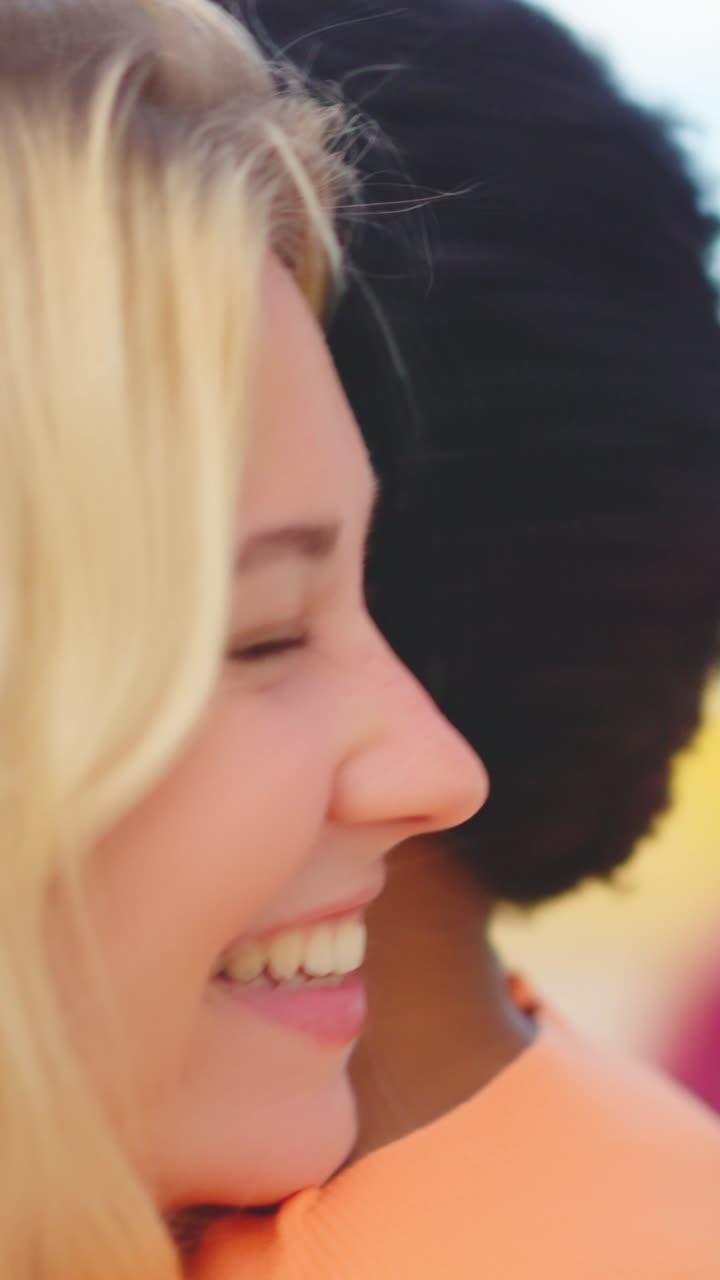 Long hug between multi-ethnic reunited friends in the city