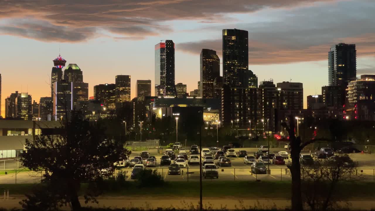 City skyscrapers and parking lot with man passing by, Calgary, Alberta, Canada
