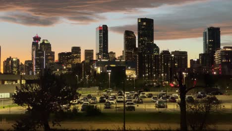 city skyscrapers and parking lot with man passing by, calgary, alberta, canada