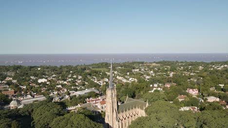 aerial of san isidro city revealing the cathedral with la plata river behind