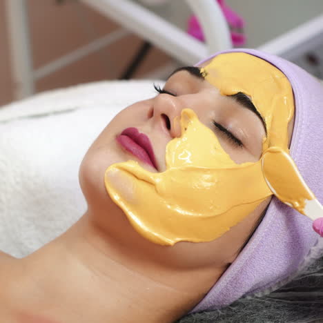 young woman gets beauty facial injections in salon. aesthetic cosmetology. application of face mask in the spa.