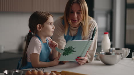 happy-mother-and-daughter-is-learning-to-cook-in-home-kitchen-mom-and-child-are-spending-weekend-together