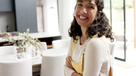 Portrait-of-happy-mature-caucasian-woman-with-long-curly-hair-smiling-at-home,-slow-motion