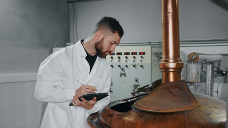 brewery worker monitoring brewing process