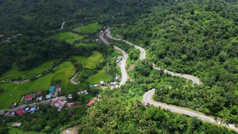 mountainside road to countryside village in bato, catanduanes, philippines. aerial drone shot
