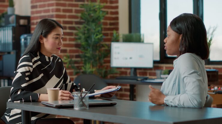 Multiethnic team of women meeting to discuss company vacancy