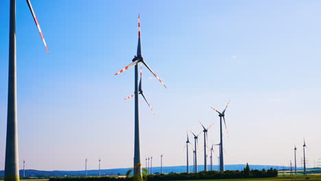 turbines create clean energy. wind turbines are using wind to generate clean energy against a bright blue sky at a renewable energy site