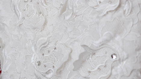 extreme close up rack focus of the fabric of a wedding dress