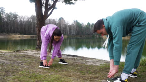 Couple-stretching-outdoors