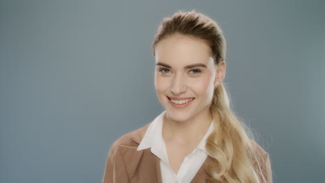 female professional smiling on grey background