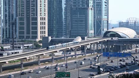 a dubai metro train approaches the station, heading to its next stop along sheikh zayed road in dubai, uae