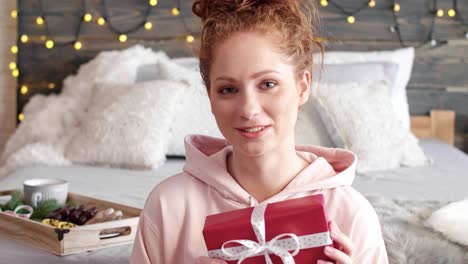 smiling girl showing the christmas presents