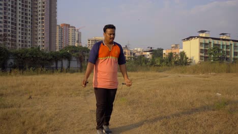 fat boy man jumping skipping rope for weight loss in morning uhd