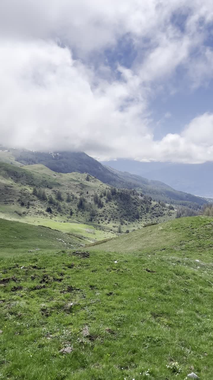 Vertical perspective of alpine meadows and misty peaks near Col de Chorges