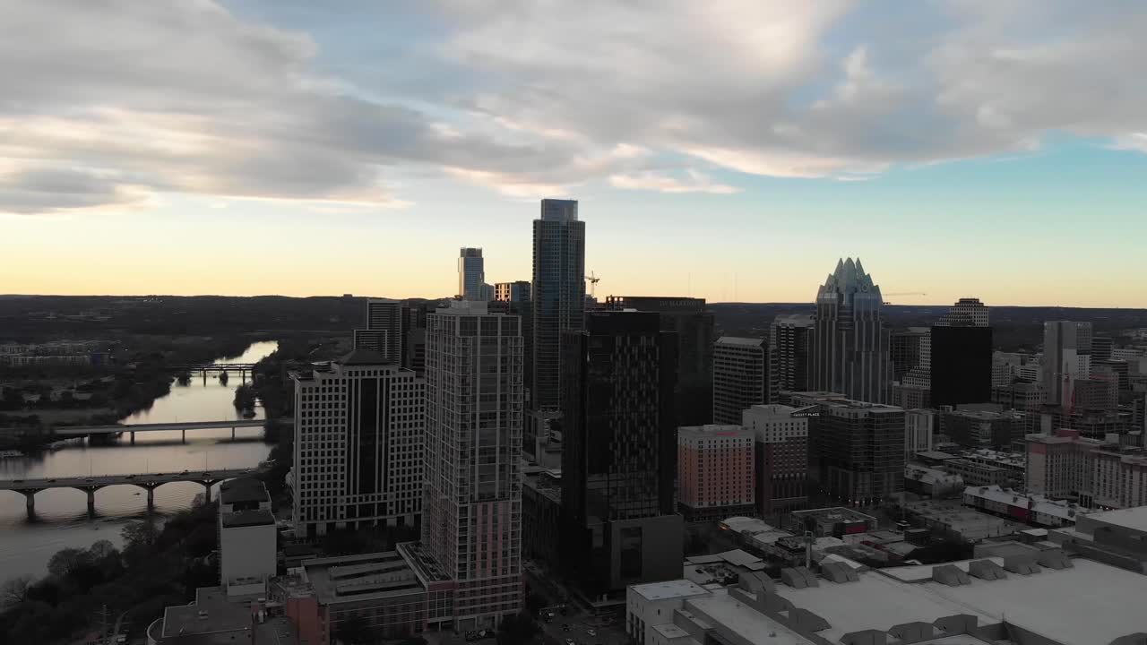Aerial drone shot of downtown Austin TX. Facing west and slowly panning north. Shot at sunset for a soft ambient glow. Shot on 2-25-20.