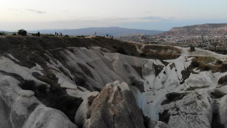 at sunset time a mavic air lifts beyond the viewpoint slowly revealing some fairy chimneys and the valley