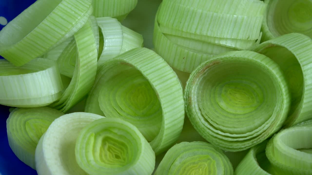 Rotating fresh cutted vegetable leek background