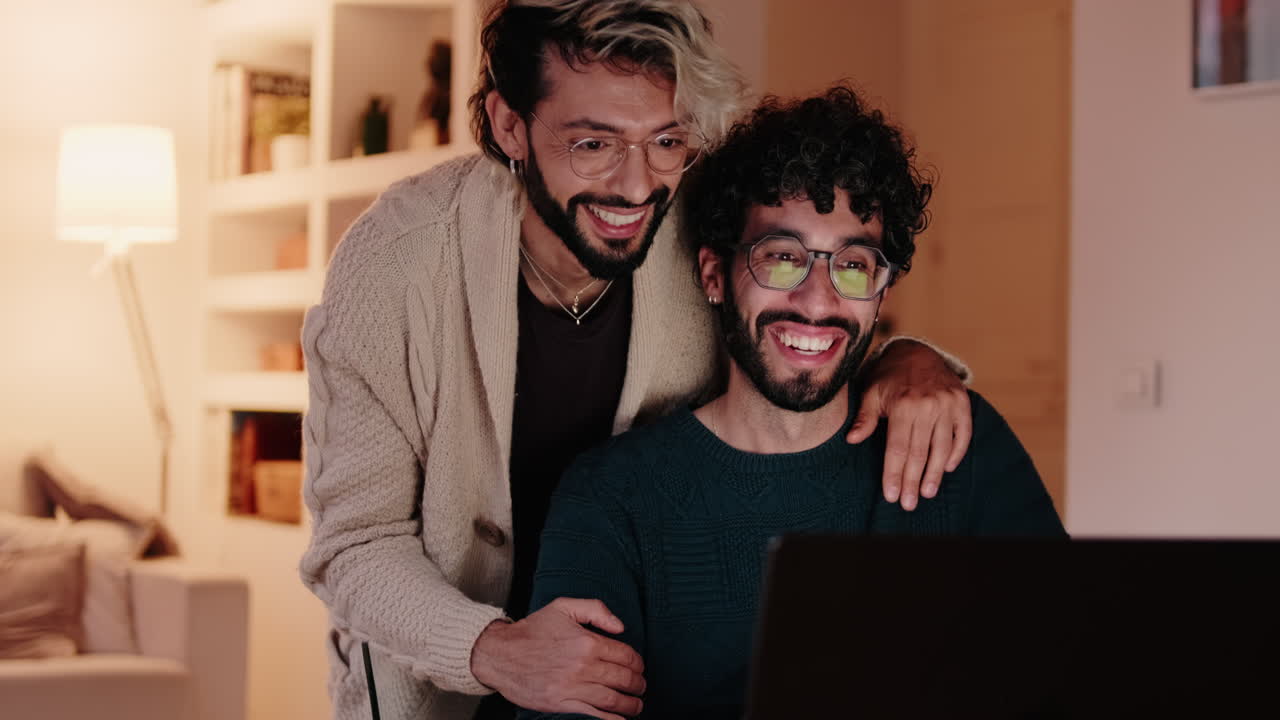 Gay Couple Video Chatting on Laptop at Home