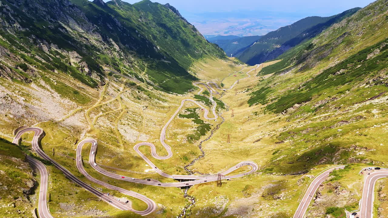 Aerial view of Transfagarasan road winding through the Carpathian Mountains. Curving Transfagarasan road runs across the Carpathian landscape in Romania