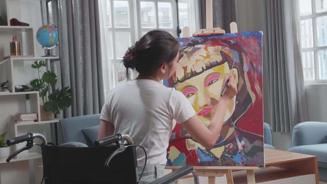 Woman in Wheelchair Painting a Portrait