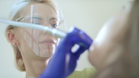 dental hygienist polishing patient teeth. professional teeth cleaning in clinic