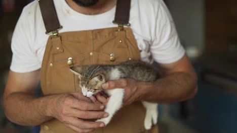 strong man holding a small kitten