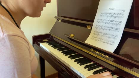 woman playing piano at home