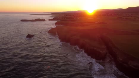 aerial sunset view of rock bound ocean cliff formation in galicia region north of spain praia das catedrais is on the northwest coastline