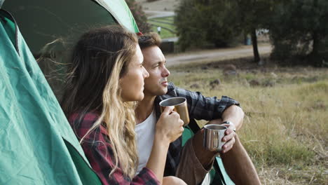 couple of happy pensive hikers drinking coffee