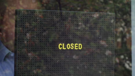 placing a closed sign in the window