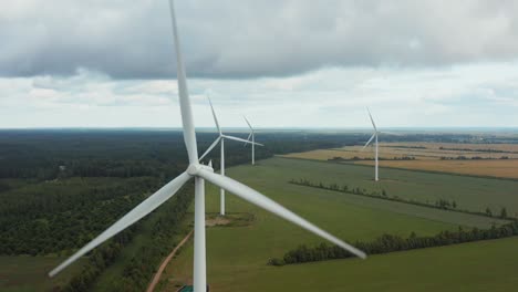 aerial close up of a wind turbine park in the background