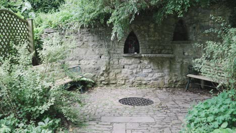 chalice well gardens in glastonbury, meditation and prayer corner with two benches, 4k slow motion