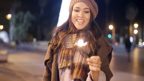 pretty young woman celebrating with a sparkler