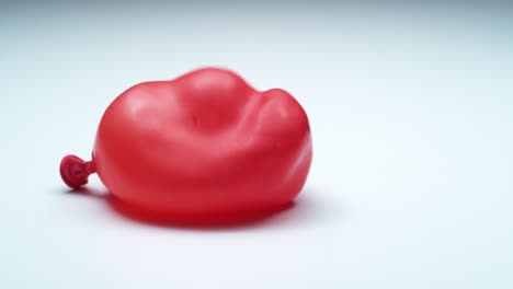 red water balloon bouncing in super slow motion.  shot on phantom flex 4k.