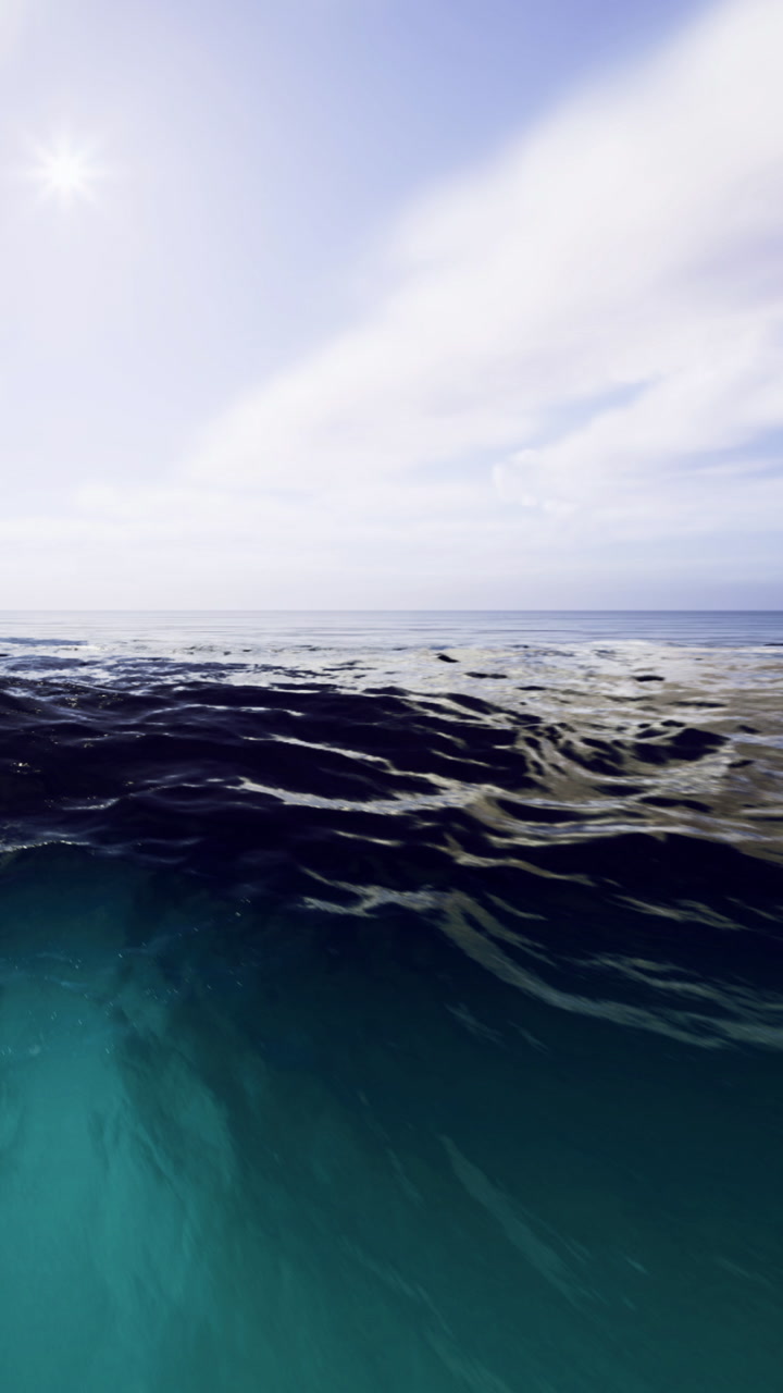 Vibrant ocean waves dance under a serene sky at midday