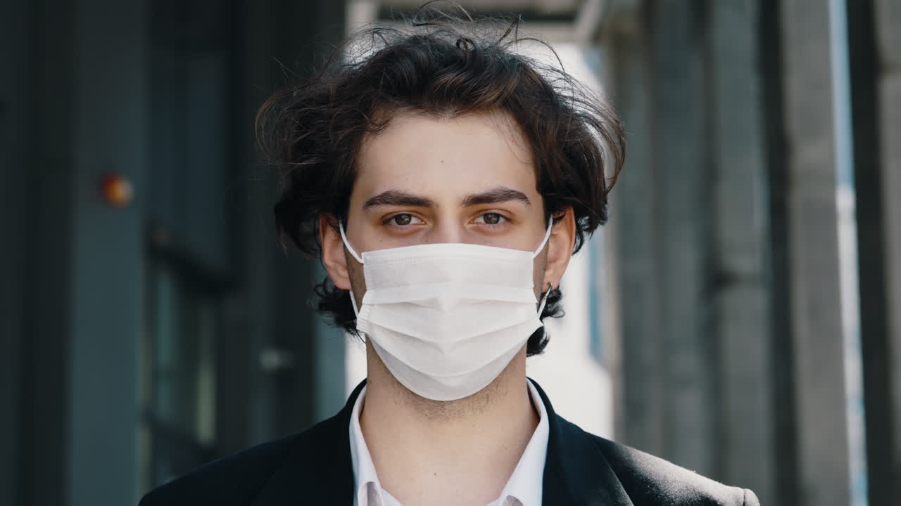 Close-up of a Young Man Wearing a Face Mask Outdoors