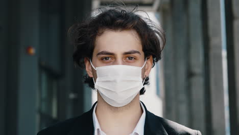 close-up of a young man wearing a face mask outdoors
