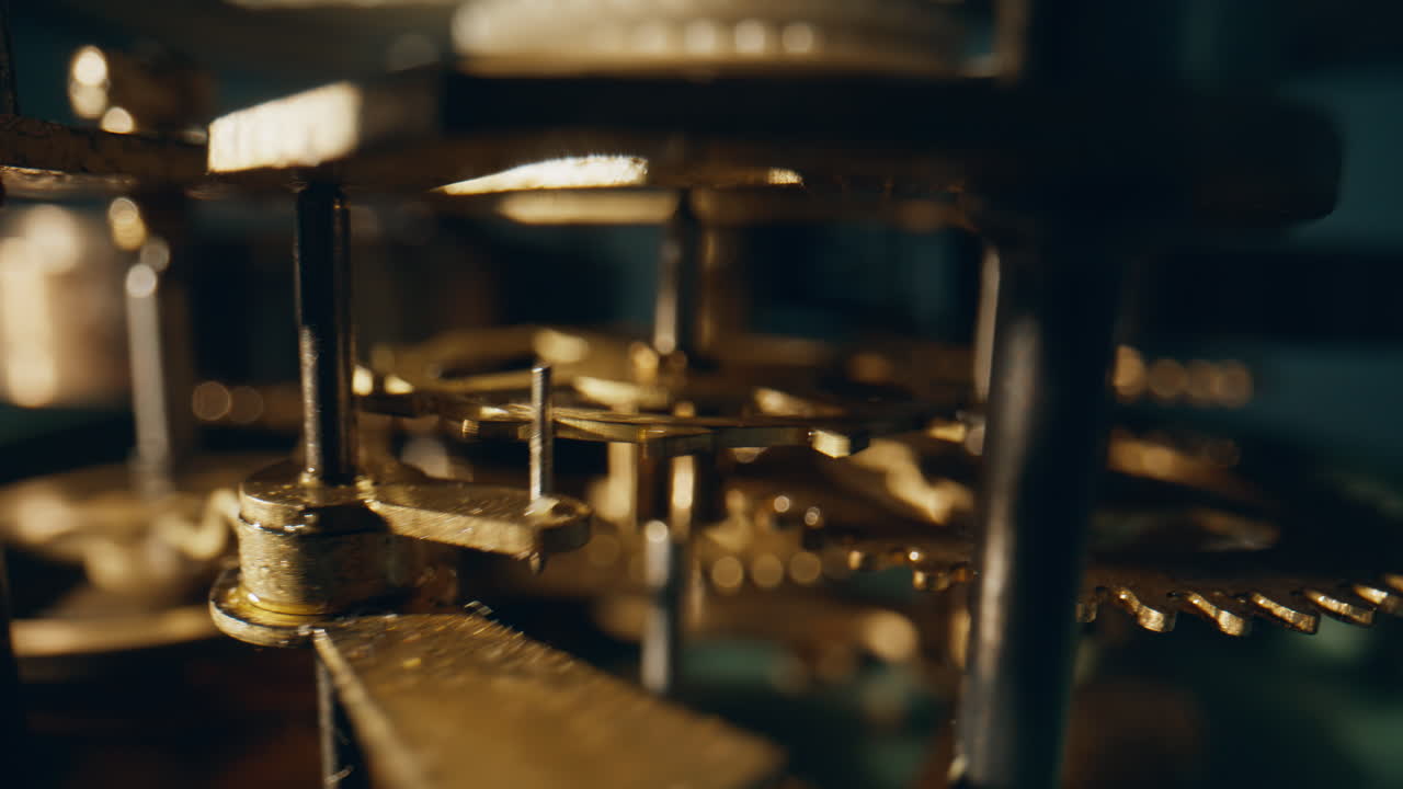 Spinning teeth interlocked gears located inside time device closeup. Macro view