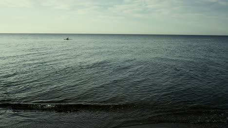 tranquil ocean water background in calm nature outside. sea waves on sunset sky.